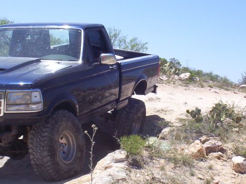 1992 Ford F-150 - This 1992 Ford F-150 pickup truck navigates a , off-road terrain under a clear blue sky.