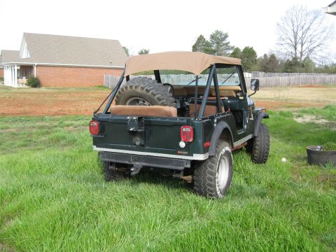 1988 Ford Bronco - This Jeep CJ-5 is shown from the rear, with its spare tire prominently displayed in the cargo area.