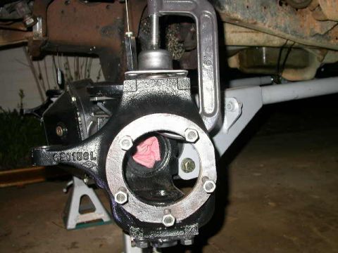 1990 Ford Bronco - Mounted the knuckles. It takes a clamp to compress the spring enough to get the cap bolts started.