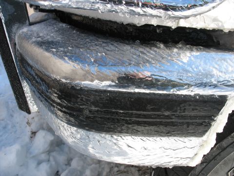 1995 Ford C-350 (Centurion Conversions) - Vehicle's front bumper is completely covered in ice after a winter storm.
