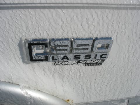 1995 Ford C-350 (Centurion Conversions) - Emblem reads "C350 CLASSIC POWER STROKE DIESEL" on a textured white surface.