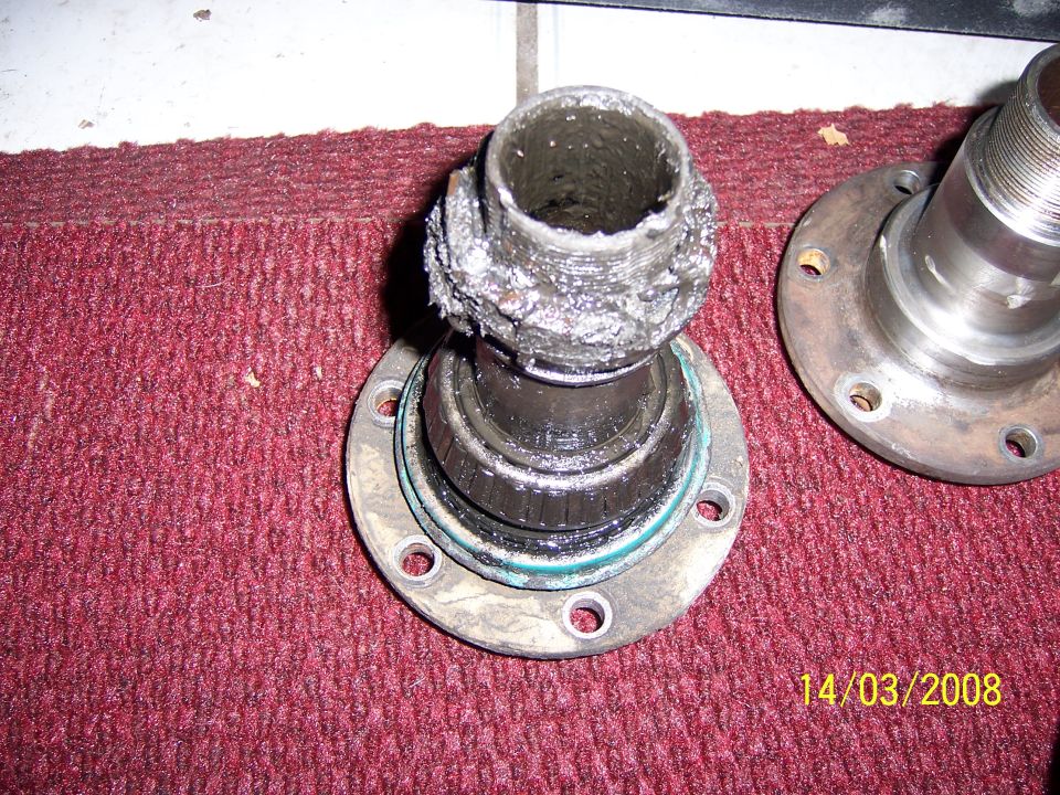 Damaged wheel bearing assembly with grease and metal debris