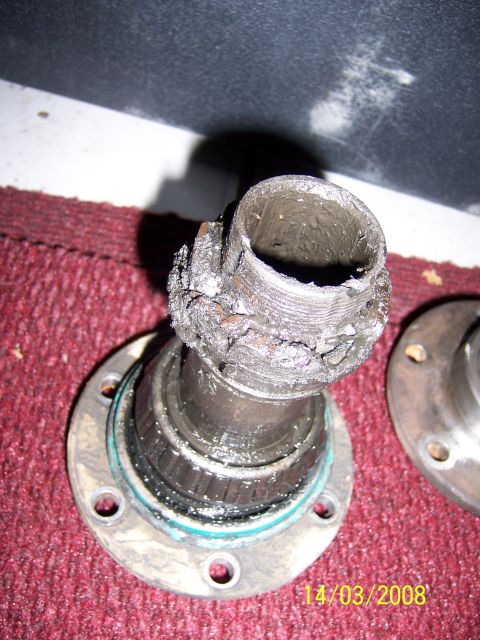 1991 Ford Bronco - Close-up of a seized wheel bearing and hub assembly, showing significant wear and damage.