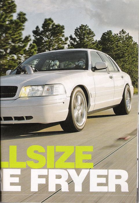 1998 Ford Crown Victoria - magazine page showing a white four-door sedan in motion on pavement, overlaid with the headline text 'FULLSIZE TIRE FRYER'.