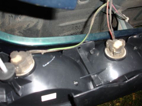 1993 Ford Taurus - Close-up of a vehicle's rear tail light housing, showing wiring and bulb sockets.