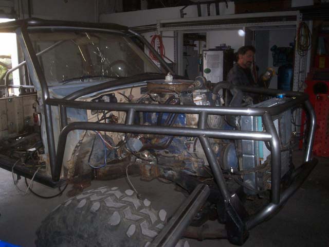 Toyota 4Runner with custom roll cage, front view, showing engine and radiator