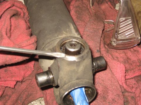 1990 Ford F-250 - A driveshaft universal joint is being worked on, with red shop rags underneath.
