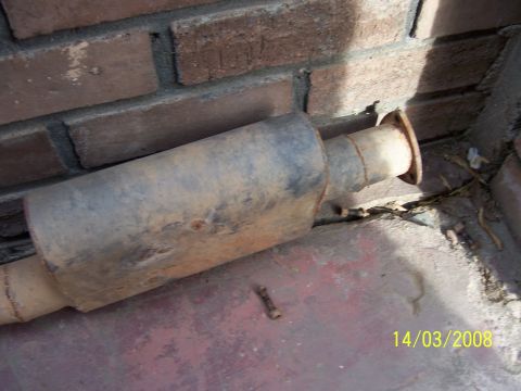 1991 Ford Bronco - A rusty exhaust muffler is shown resting against a brick wall, with a date stamp of 14/03/2008 in the corner.