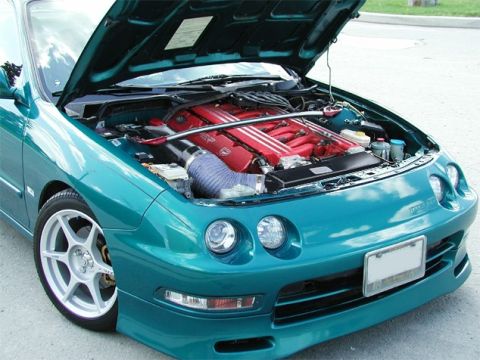 1980 Ford Bronco - Teal coupe with hood open, revealing a red V6 engine and aftermarket modifications.