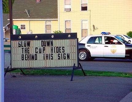 1980 Ford Bronco - A police car is visible next to a changeable message sign with a humorous warning.