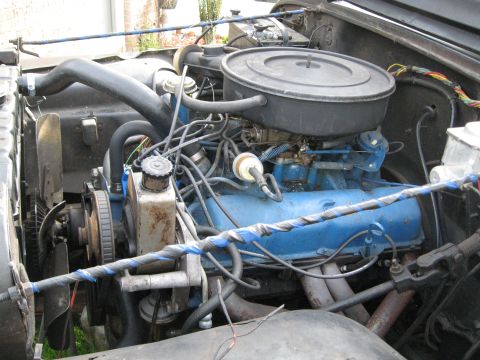1988 Ford Bronco - Close-up view of a vehicle's engine bay, showing various components and wiring.