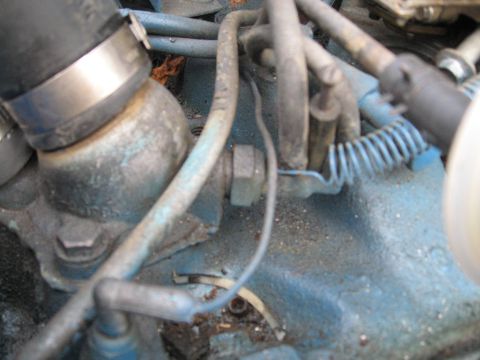 1988 Ford Bronco - Engine bay detail showing hoses, wiring, and a bolted component.
