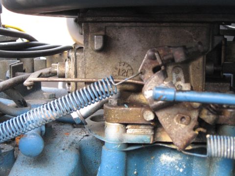 1988 Ford Bronco - This image shows a detailed view of a vehicle's carburetor, highlighting its mechanical components and a stamped numerical marking.