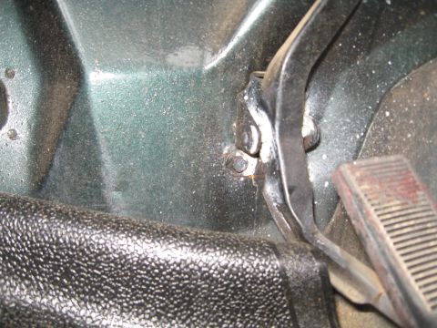 1988 Ford Bronco - Close-up view of the interior footwell, showing the brake and clutch pedals and textured trim.