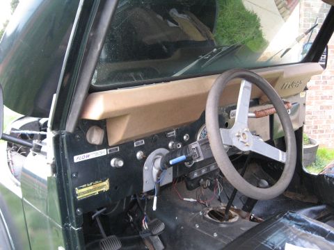 1988 Ford Bronco - Interior view of a Jeep CJ, the dashboard, steering wheel, and shifter mechanism.