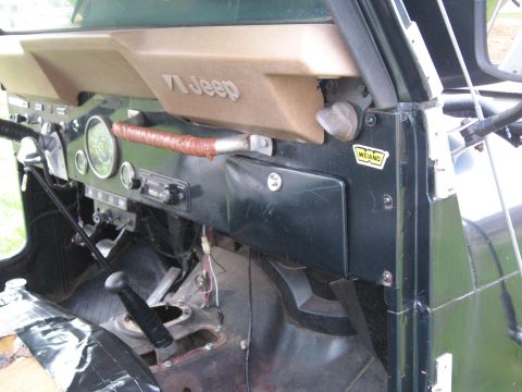 1988 Ford Bronco - The interior of a Jeep CJ shows a '71 Jeep badge and various dashboard components.