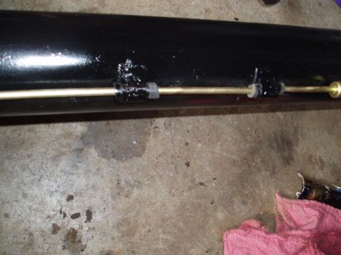 1980 Ford Bronco - Close-up of a vehicle exhaust pipe with attached hardware.