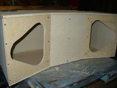 1993 Ford Probe - This unfinished speaker box is constructed from particle board and features two large triangular openings.