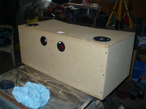 1993 Ford Probe - A wooden speaker box is shown with multiple speaker openings, resting on a surface with tools and debris.