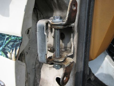 1980 Ford Bronco - This photo shows a close-up view of a vehicle's door hinge, focusing on the pivot and mounting points.