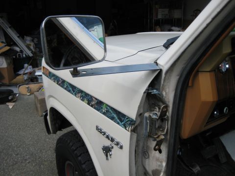 1980 Ford Bronco - Close-up of a 1980 Ford Bronco fender showing a camouflage stripe and an aftermarket mirror mount.