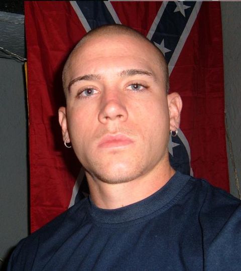 1995 Ford Bronco - A man poses for a photo in front of a Confederate flag, with a website logo visible at the bottom.