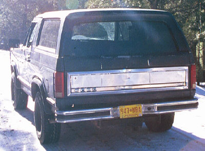 1980 Ford Bronco - Rear view of a 1980 Ford Bronco, showing its distinctive body style and chrome tailgate trim.