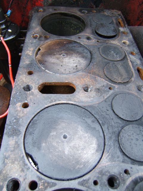 1946 Jeep CJ5 - Close-up view of a used engine cylinder head, showing valves and bolt holes.