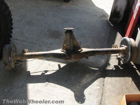 1987 Suzuki Samurai - This is a vehicle axle assembly, likely from an older 4x4, showing signs of rust and wear.