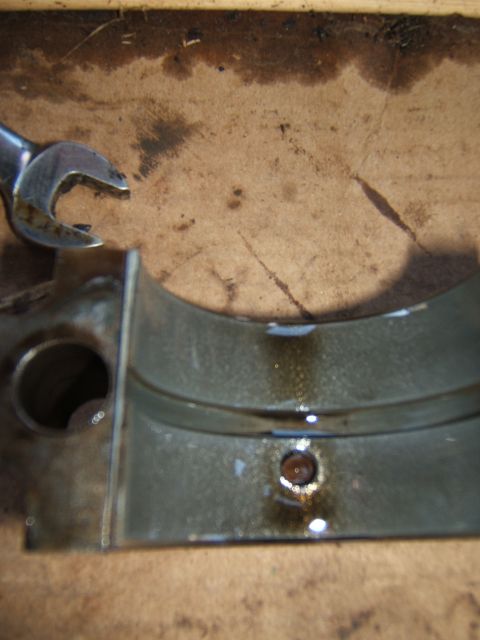 1946 Jeep CJ5 - A close-up view of an engine bearing and a wrench, suggesting automotive repair work.