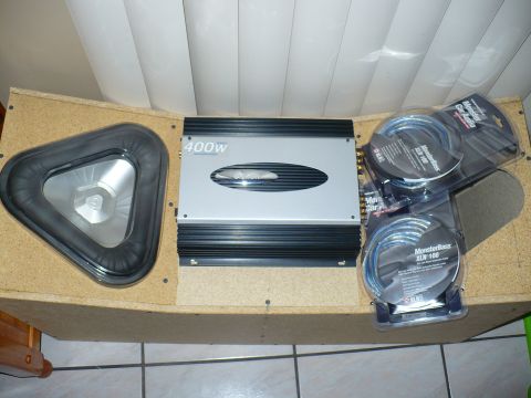 1993 Ford Probe - A car audio setup an amplifier, subwoofer, and speaker wire is shown.
