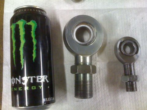 1966 Ford Bronco - Two rod ends, one large and one small, displayed next to a Monster energy drink can.
