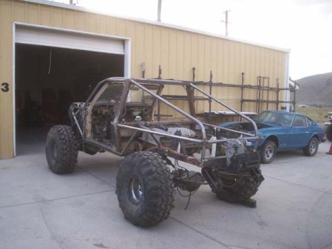 1982 Toyota 4Runner - Custom off-road buggy under construction, with a blue coupe parked nearby.