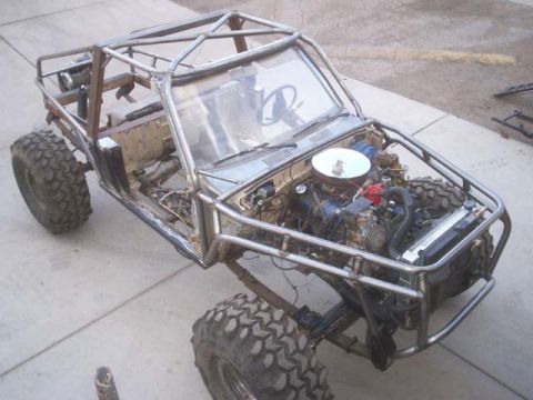 1982 Toyota 4Runner - This custom-built buggy is undergoing modifications, a prominent roll cage and exposed engine components.