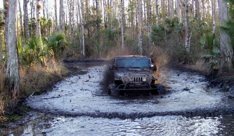2004 Jeep TJ - Jeep TJ navigates a challenging muddy off-road course.