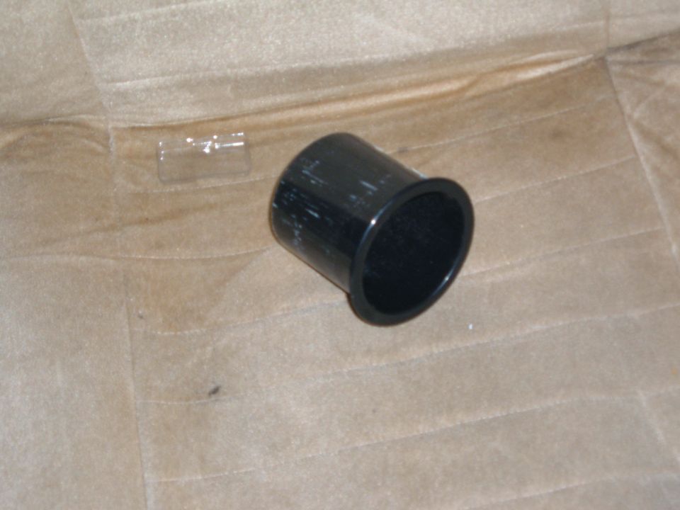 black plastic cup holder on tan fabric