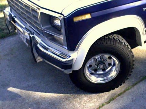 1981 Ford Bronco - This 1980s SUV features a prominent chrome bumper and white fender flares, highlighting its front corner.