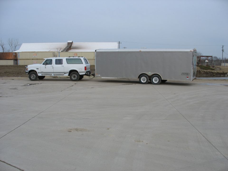 1995 Ford C-350 (Centurion Conversions) SUV towing a silver tandem-axle trailer