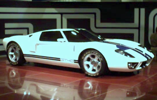 White sports car with blue stripes and 'GT40' badging on the side