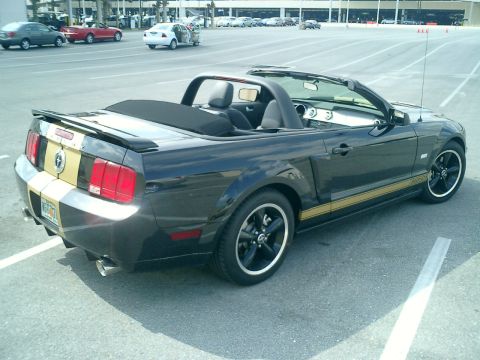 2007 Ford Mustang - This black convertible Mustang features gold racing stripes and a black soft top.