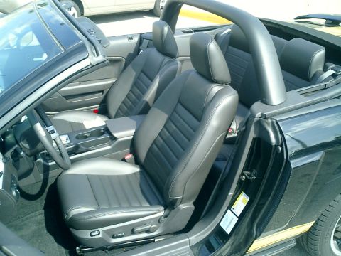 2007 Ford Mustang - Interior view of a black convertible with leather seats and a roll bar.