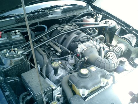 2007 Ford Mustang - The engine compartment of a 2007 Ford Mustang is visible, with the hood open.