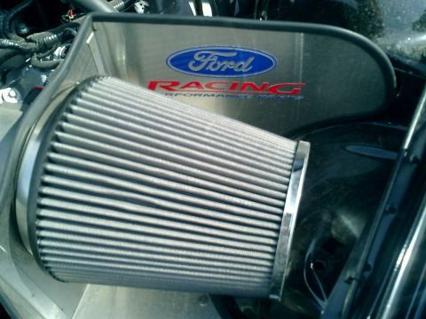 2007 Ford Mustang - Close-up of a Ford Racing cold air intake system with a prominent Ford logo.