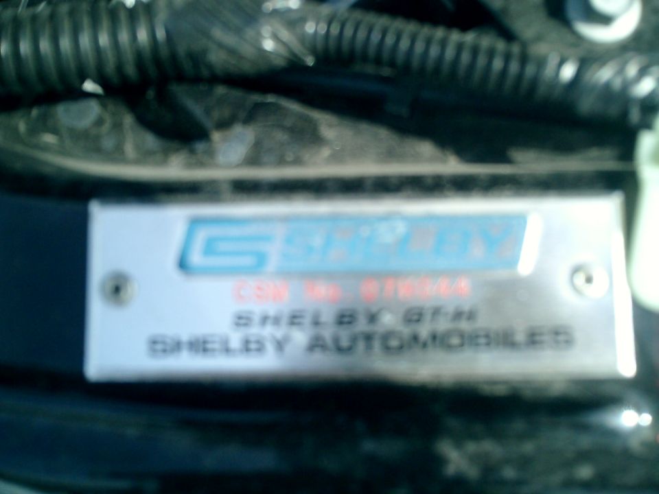 Metal identification plate with Shelby Automobiles logo and text: CSN NO. 07SGH28, SHELBY GT-H, SHELBY AUTOMOBILES