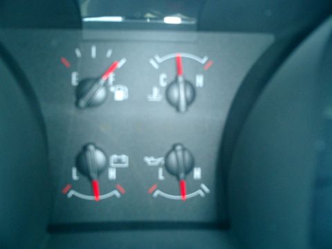 2007 Ford Mustang - The gauge cluster of a 2007 Ford Mustang displays readings for fuel, engine temperature, battery charge, and oil level.