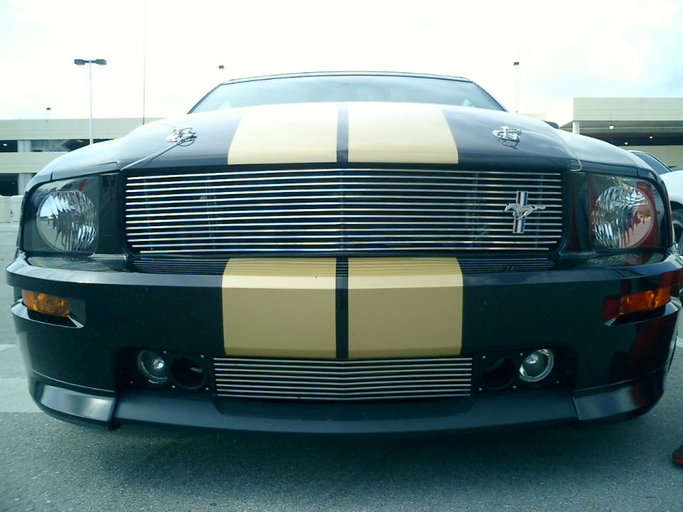 Black 2007 Ford Mustang front view with gold stripes and chrome grille