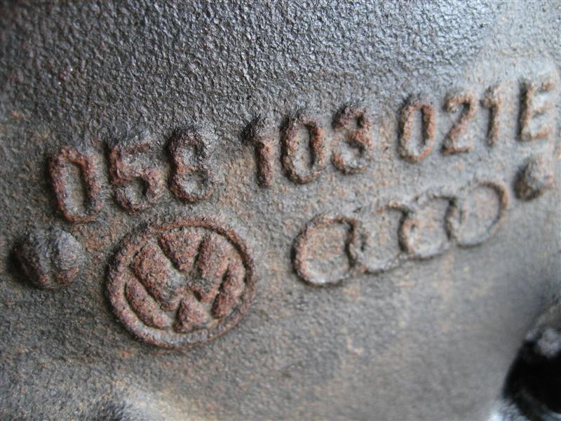 Engine part with embossed Volkswagen logo and Audi rings, and part number 058 103 021 E