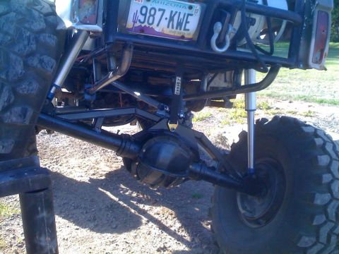 1966 Ford Bronco - Custom suspension and rear axle assembly visible on an off-road vehicle, an Arizona license plate dated 2005.