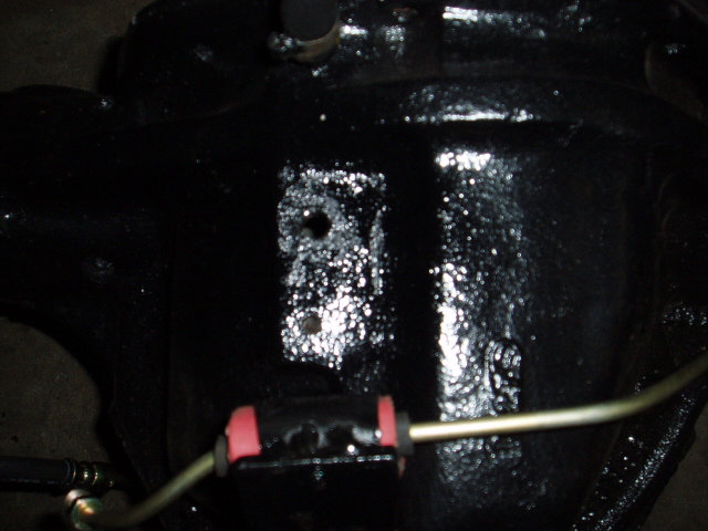 Close-up of a black vehicle differential housing with some metal lines attached