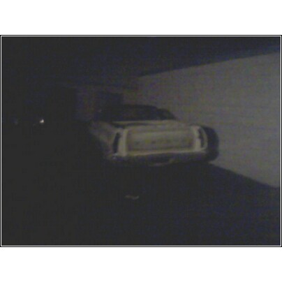 1972 Ford Ranchero - The rear of a car is visible in a dimly lit indoor space.